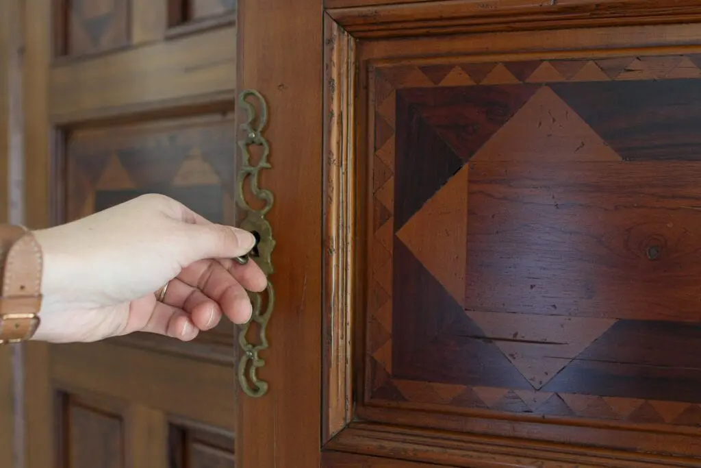 Using a key to open the antique hutch